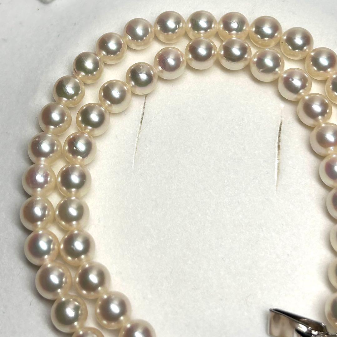 Tasaki Akoya pearl necklace with 7.5mm pearls and silver metal fittings laid flat