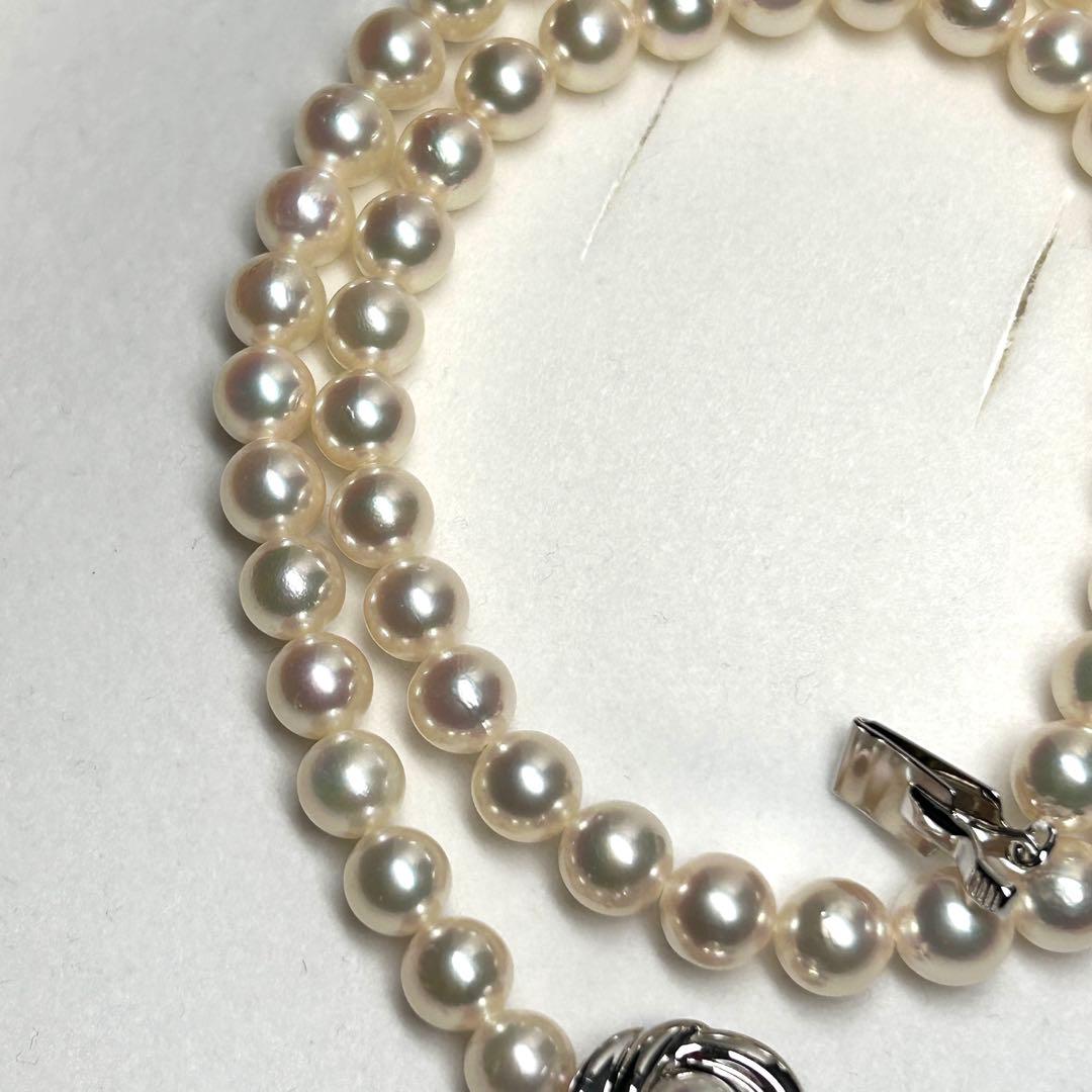 Tasaki Akoya pearl necklace with 7.5mm pearls and silver metal fittings laid flat