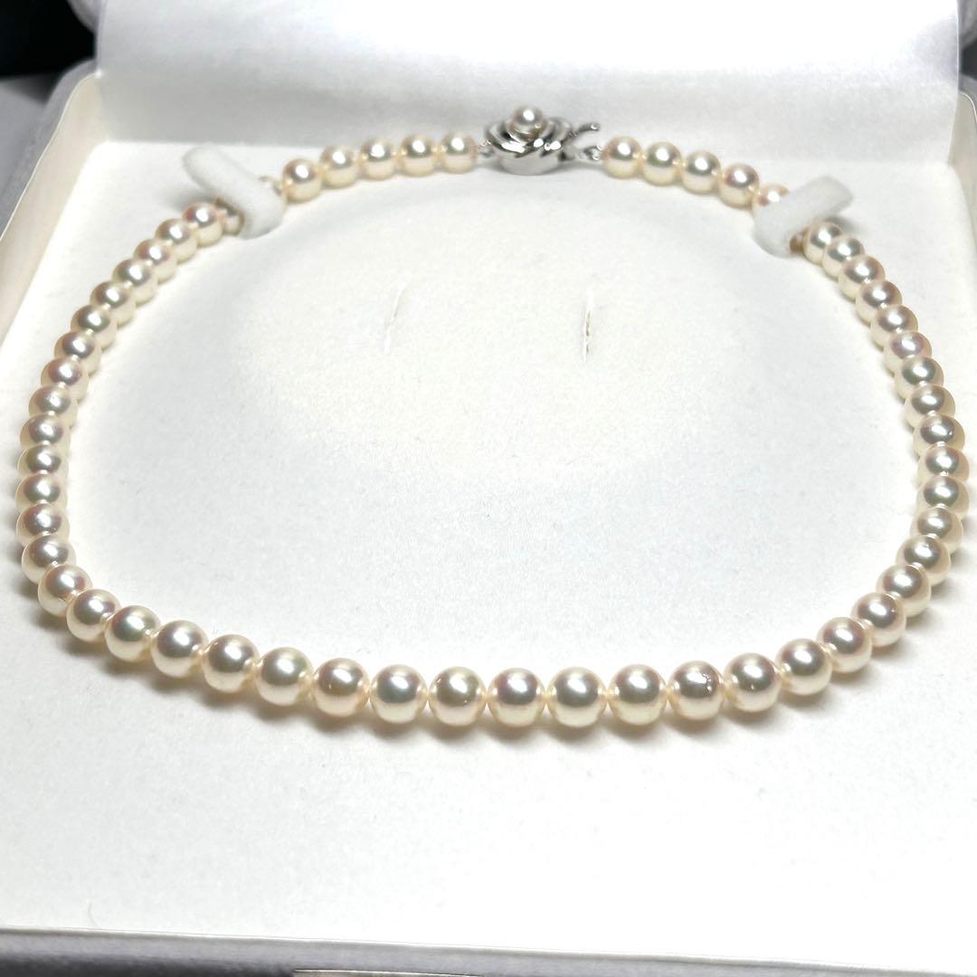 Tasaki Akoya pearl necklace with 7.5mm pearls and silver metal fittings laid flat