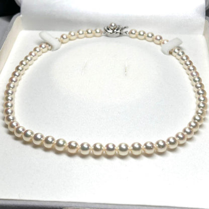 Tasaki Akoya pearl necklace with 7.5mm pearls and silver metal fittings laid flat