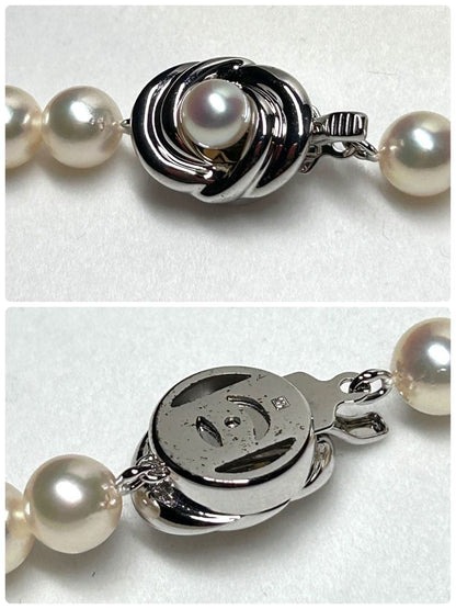 Tasaki Akoya pearl necklace with 7.5mm pearls and silver metal fittings laid flat
