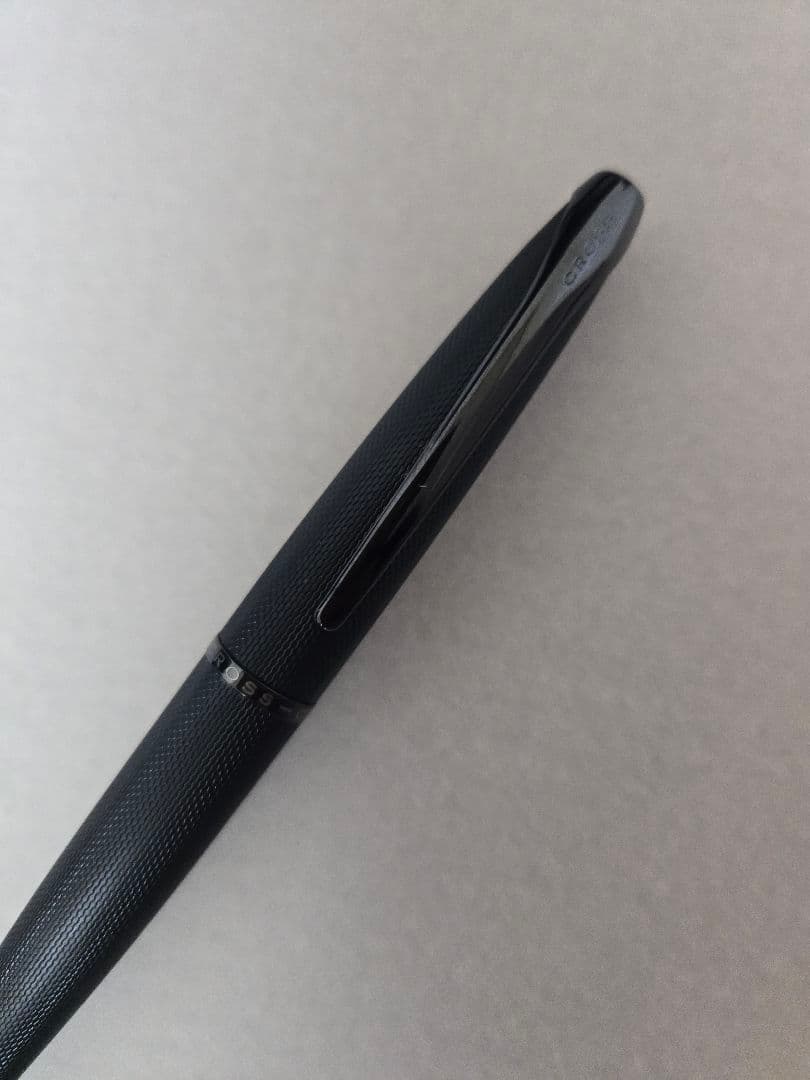 Cross black ballpoint pen with brushed metal body and twist mechanism shown