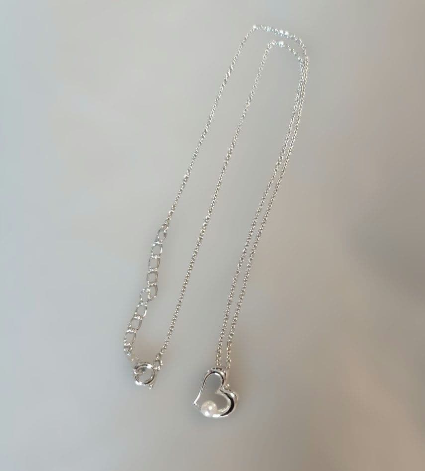 Tasaki Pearl Heart Necklace with heart motif and pearl decoration shown with dedicated case