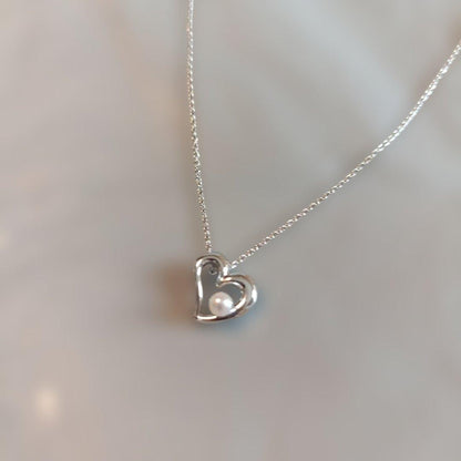Tasaki Pearl Heart Necklace with heart motif and pearl decoration shown with dedicated case