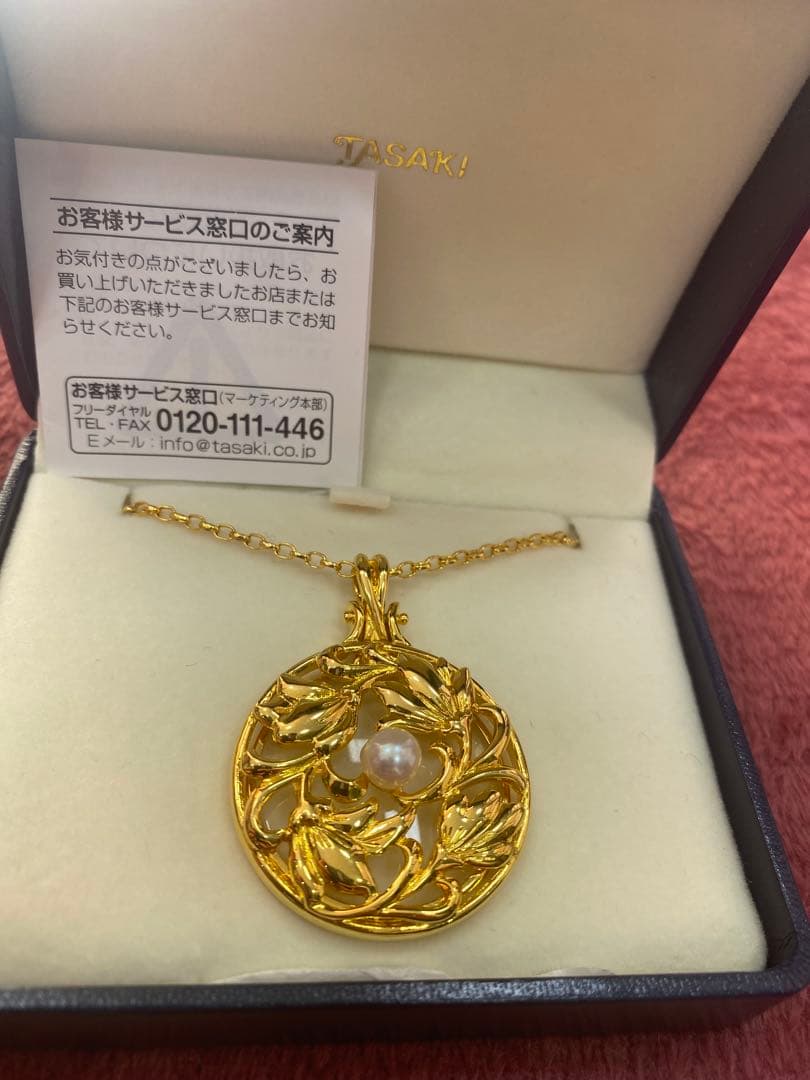 Tasaki Baby Pearl Loupe Necklace with gold color and genuine pearls displayed on a white background