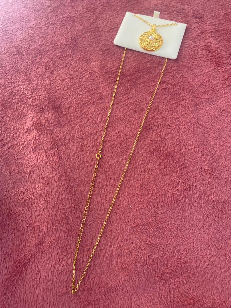 Tasaki Baby Pearl Loupe Necklace with gold color and genuine pearls displayed on a white background