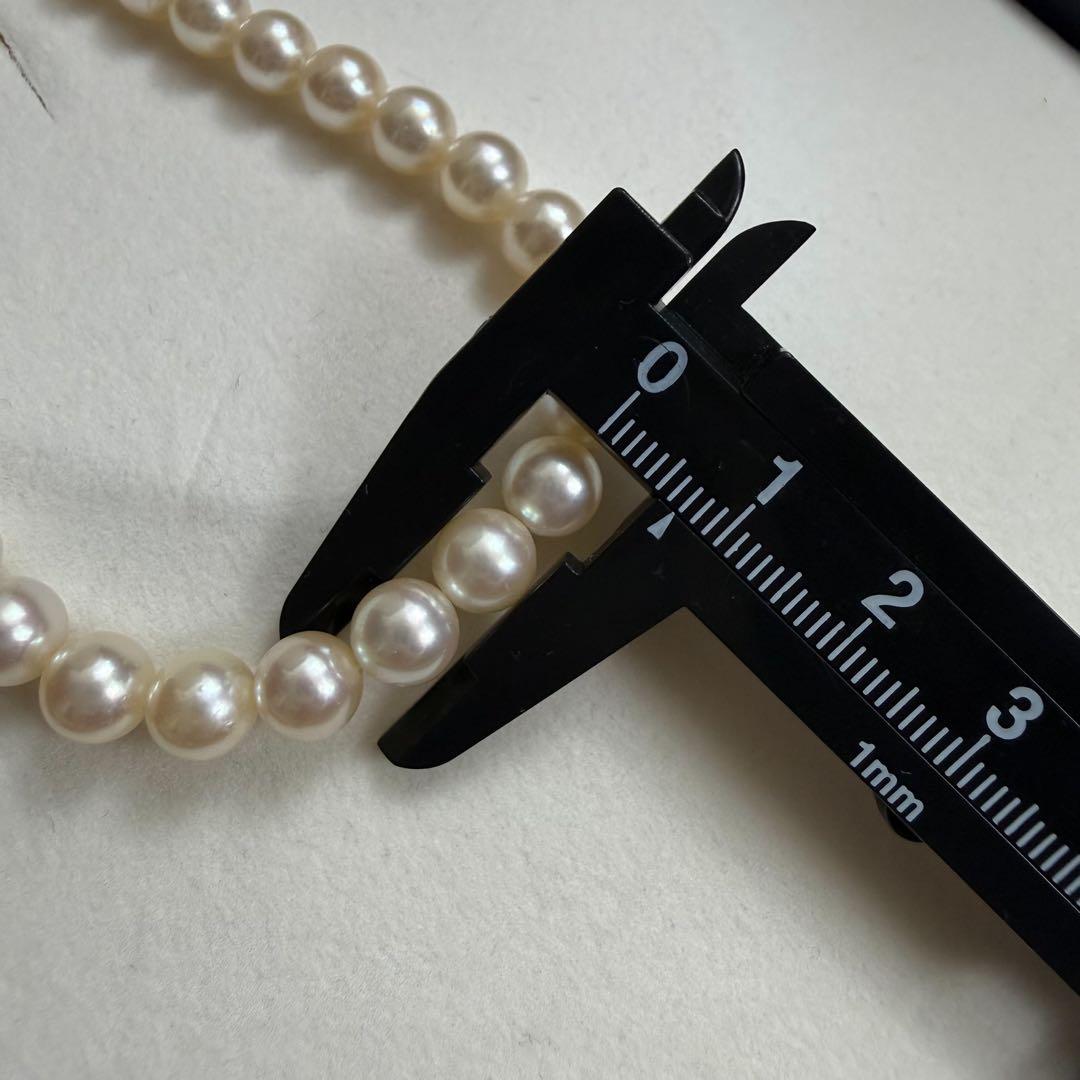 Tasaki Akoya pearl necklace with 6.5-7mm pearls and ribbon clasp displayed with jewelry box