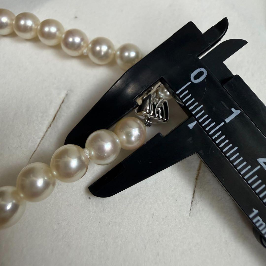 Tasaki Akoya pearl necklace with 6.5-7mm pearls and ribbon clasp displayed with jewelry box