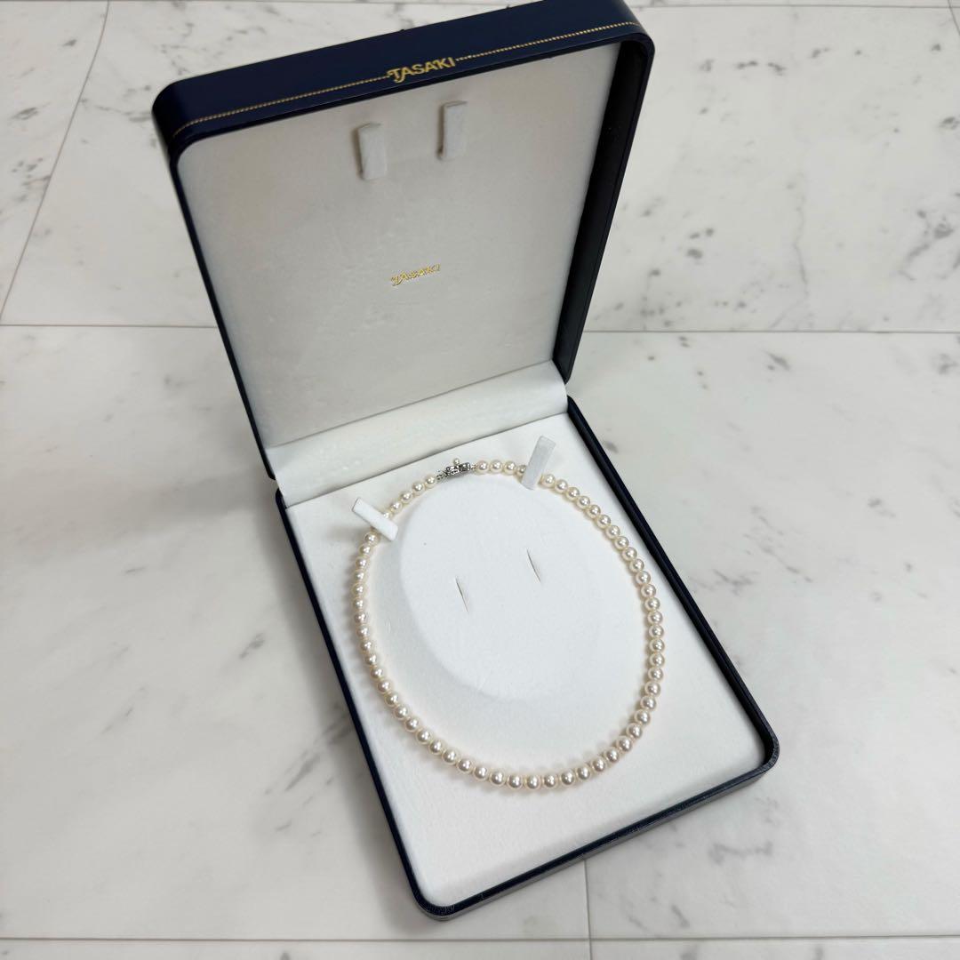 Tasaki Akoya pearl necklace with 6.5-7mm pearls and ribbon clasp displayed with jewelry box