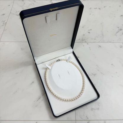 Tasaki Akoya pearl necklace with 6.5-7mm pearls and ribbon clasp displayed with jewelry box