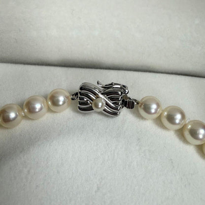 Tasaki Akoya pearl necklace with 6.5-7mm pearls and ribbon clasp displayed with jewelry box