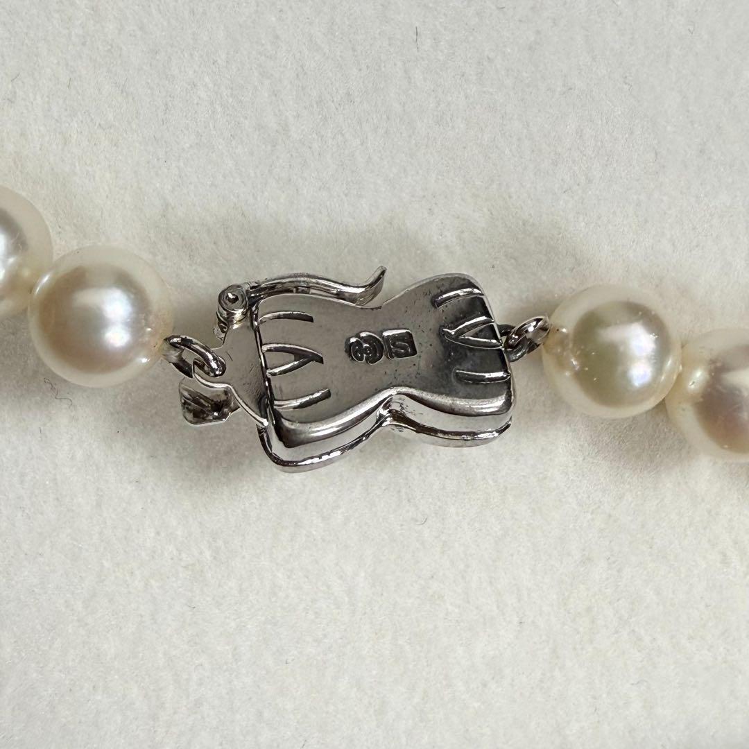 Tasaki Akoya pearl necklace with 6.5-7mm pearls and ribbon clasp displayed with jewelry box