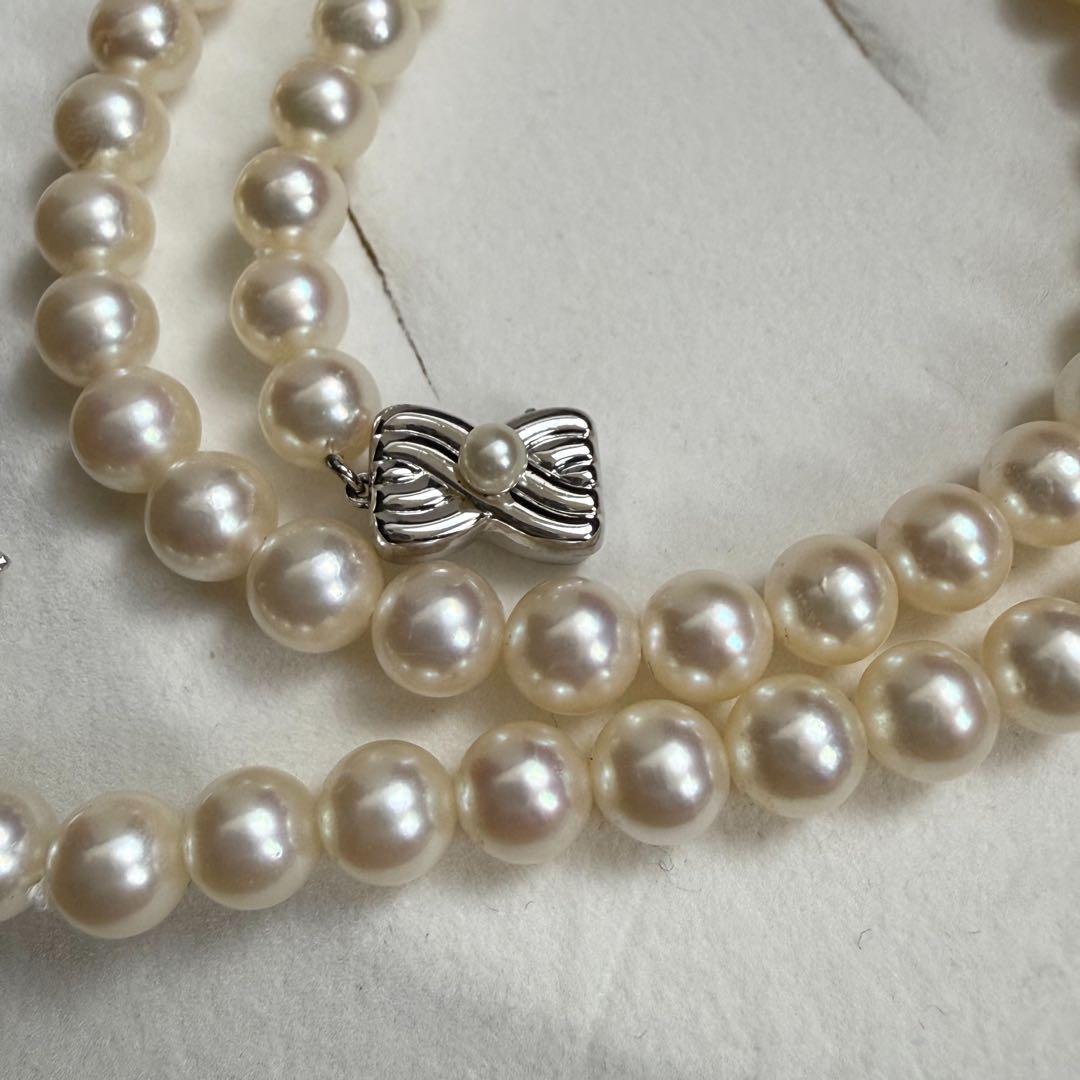 Tasaki Akoya pearl necklace with 6.5-7mm pearls and ribbon clasp displayed with jewelry box
