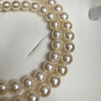 Tasaki Akoya pearl necklace with 6.5-7mm pearls and ribbon clasp displayed with jewelry box