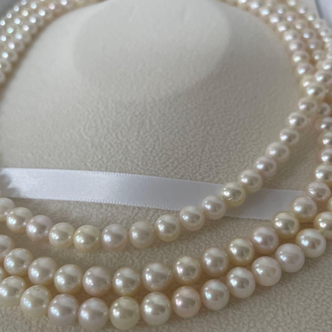 Akoya pearl necklace with 6.5-7mm round pearls, 142cm length, silver push type clasp, displayed with box