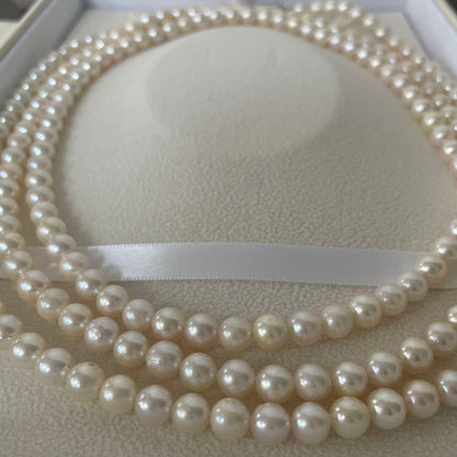Akoya pearl necklace with 6.5-7mm round pearls, 142cm length, silver push type clasp, displayed with box