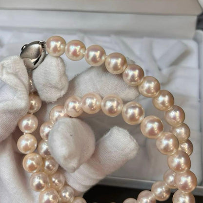 Akoya pearl necklace with white pearls sized 8.6 to 9.0mm and silver metal clasp on a white background