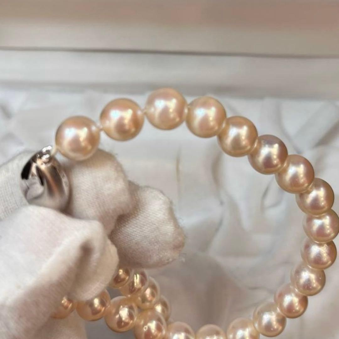 Akoya pearl necklace with white pearls sized 8.6 to 9.0mm and silver metal clasp on a white background