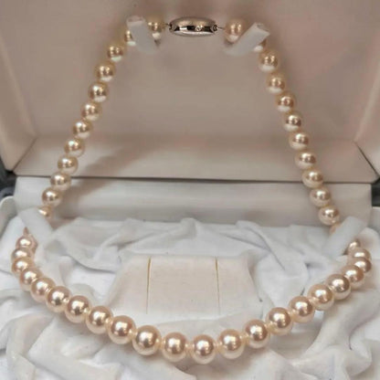 Akoya pearl necklace with white pearls sized 8.6 to 9.0mm and silver metal clasp on a white background
