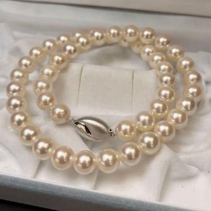 Akoya pearl necklace with white pearls sized 8.6 to 9.0mm and silver metal clasp on a white background