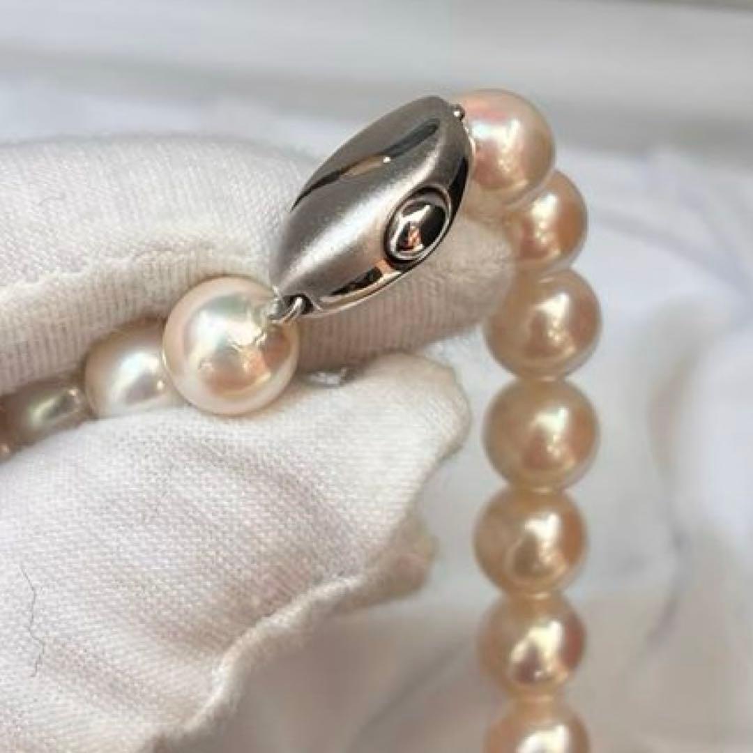 Akoya pearl necklace with white pearls sized 8.6 to 9.0mm and silver metal clasp on a white background