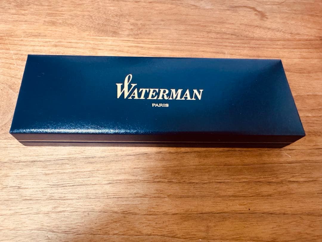Waterman black ballpoint pen main body with tip extended against white background
