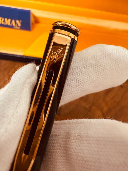 Waterman black ballpoint pen main body with tip extended against white background
