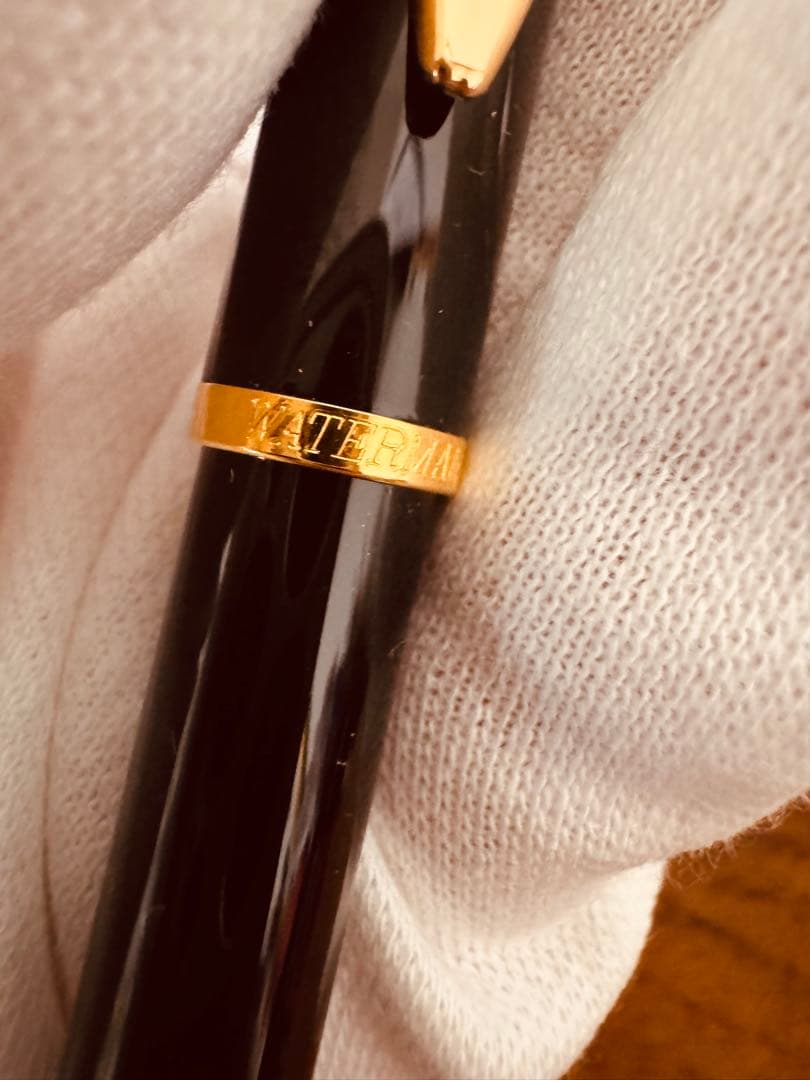 Waterman black ballpoint pen main body with tip extended against white background