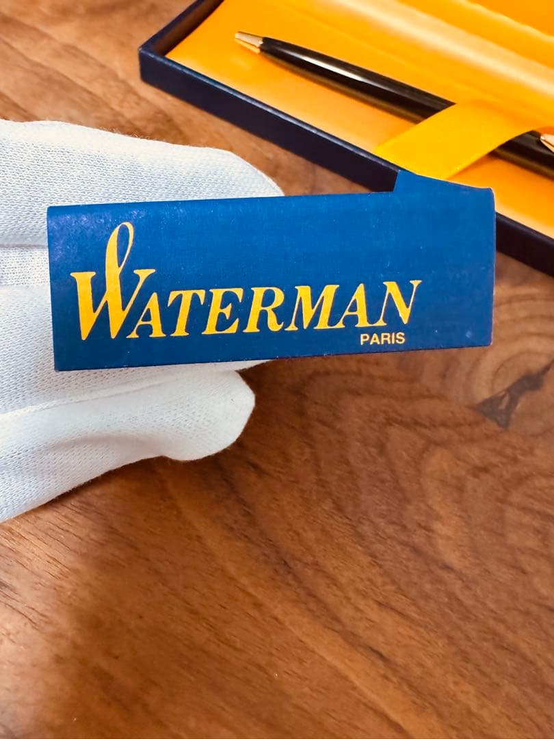 Waterman black ballpoint pen main body with tip extended against white background
