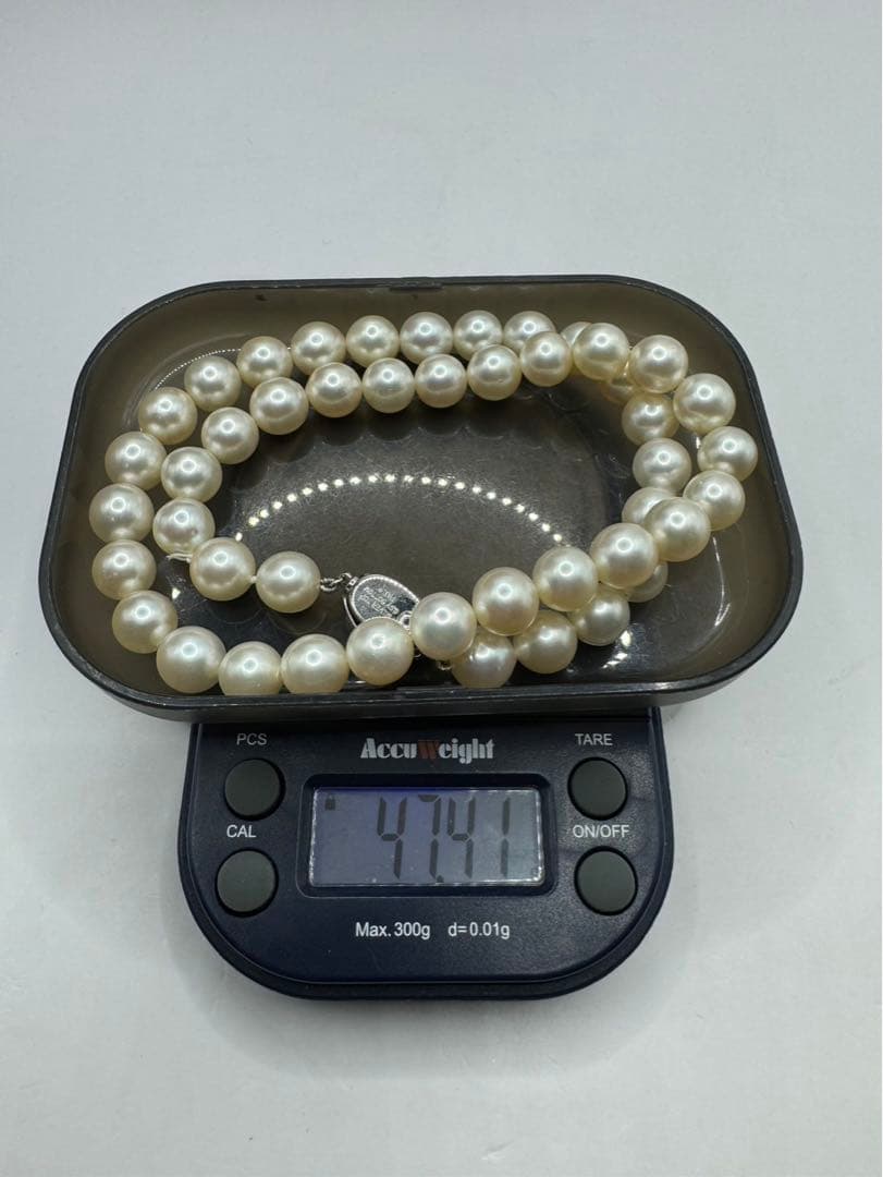 Akoya pearl silver necklace and diamond ring set with pearls sized 8.5 to 9.0 mm displayed on white background