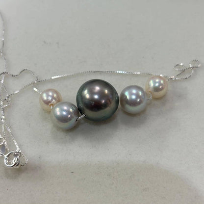 Akoya pearl necklace with black peacock pearl pendant and varying pearl sizes on a 42cm strand