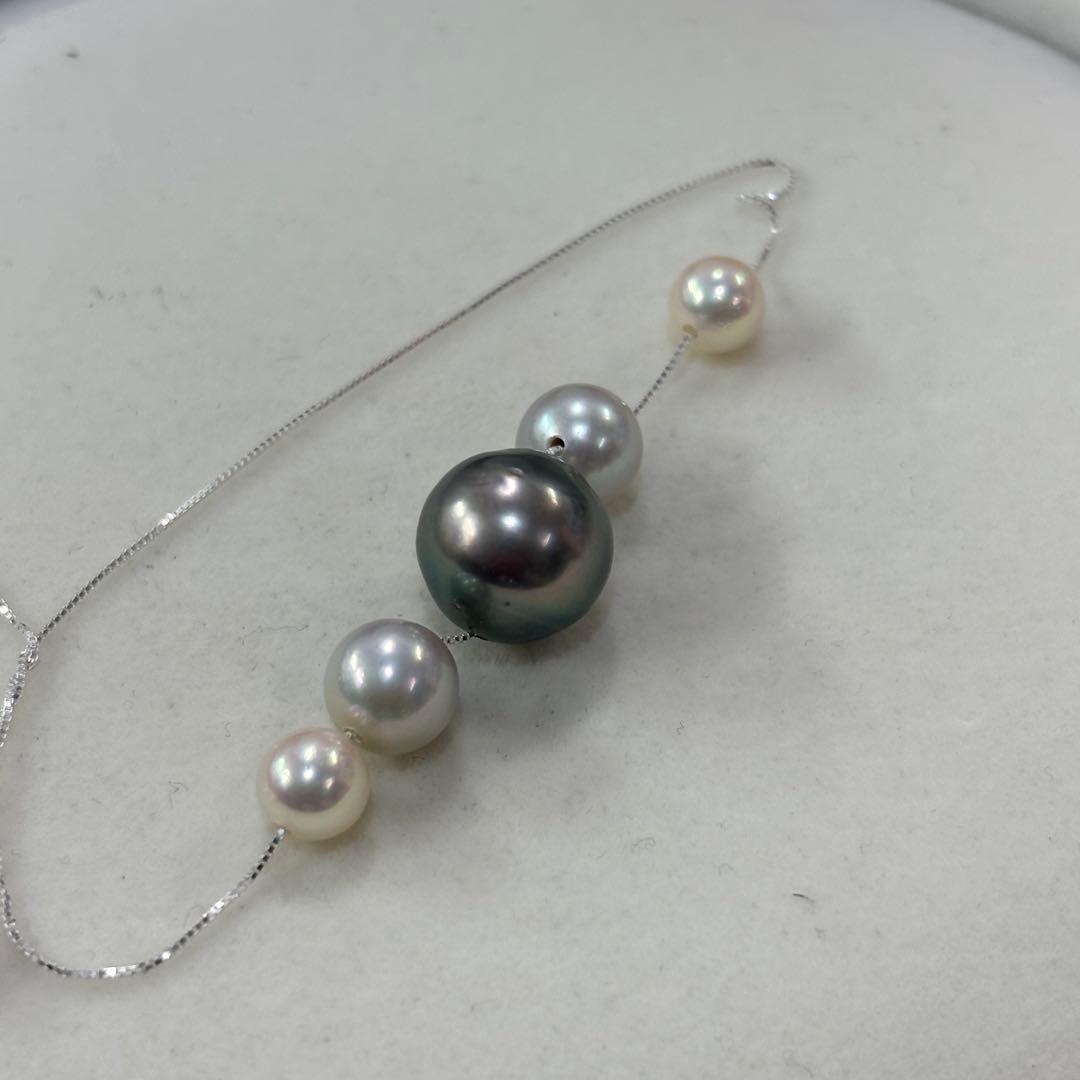 Akoya pearl necklace with black peacock pearl pendant and varying pearl sizes on a 42cm strand