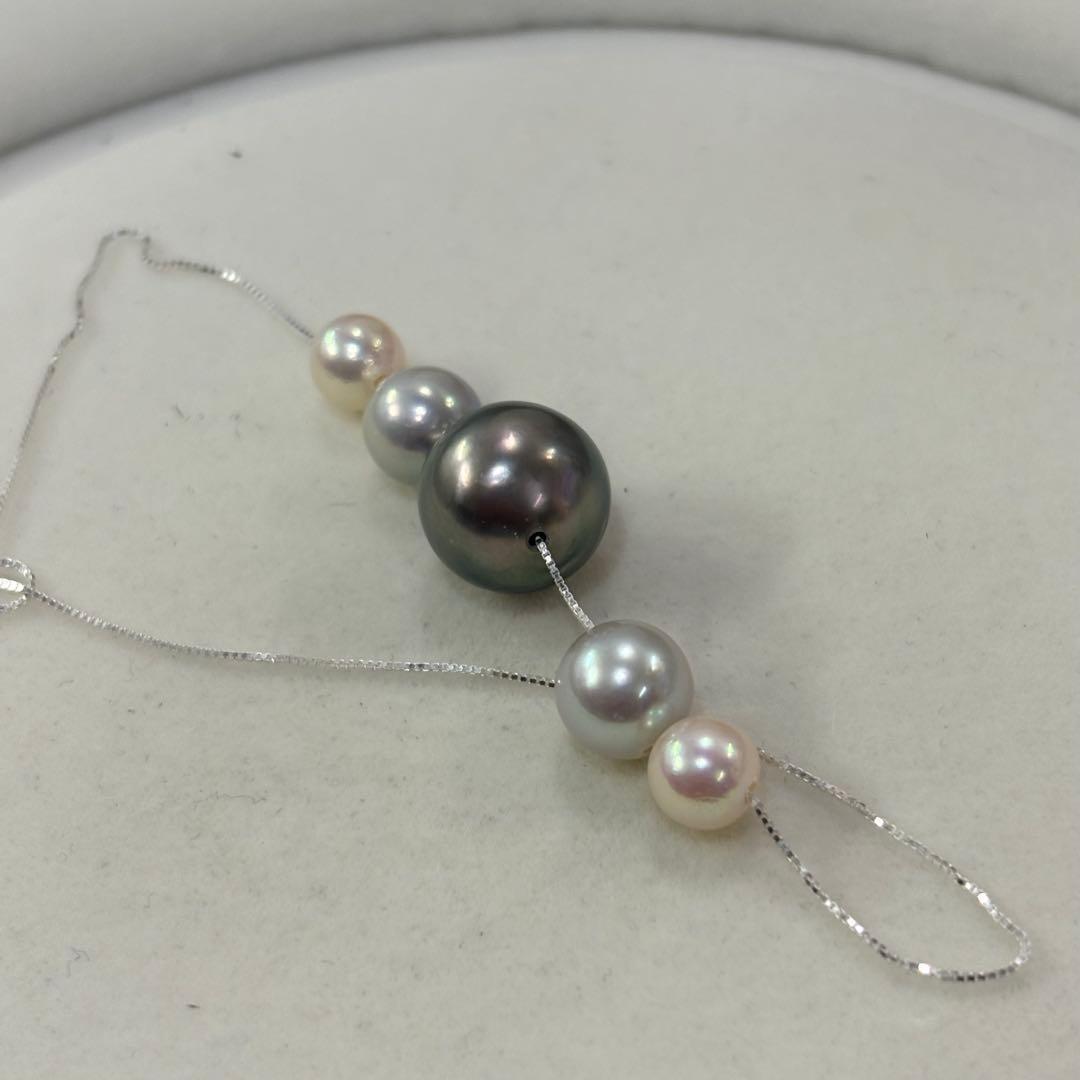 Akoya pearl necklace with black peacock pearl pendant and varying pearl sizes on a 42cm strand