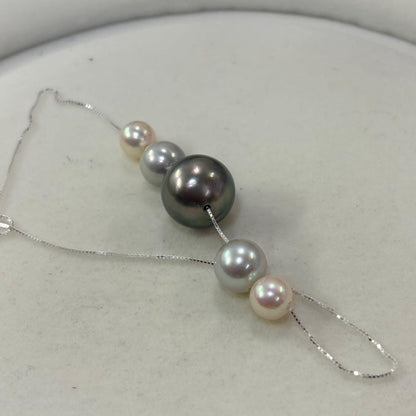 Akoya pearl necklace with black peacock pearl pendant and varying pearl sizes on a 42cm strand