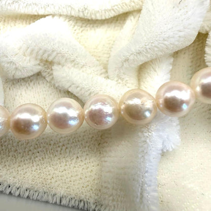 Yamato Akoya white pearl necklace with 5mm pearls and 41cm length displayed on a black background