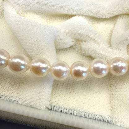 Yamato Akoya white pearl necklace with 5mm pearls and 41cm length displayed on a black background