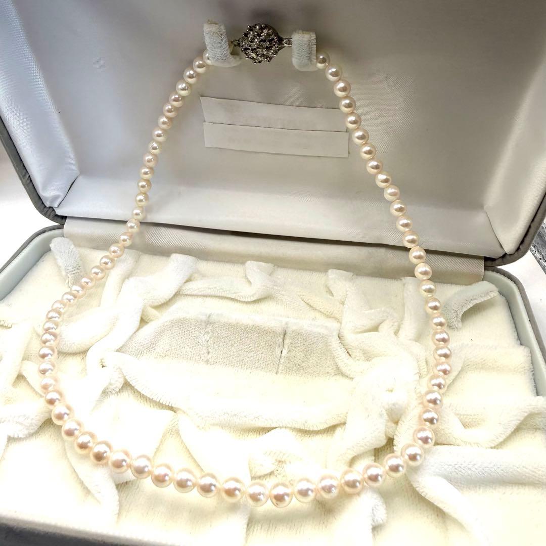 Yamato Akoya white pearl necklace with 5mm pearls and 41cm length displayed on a black background