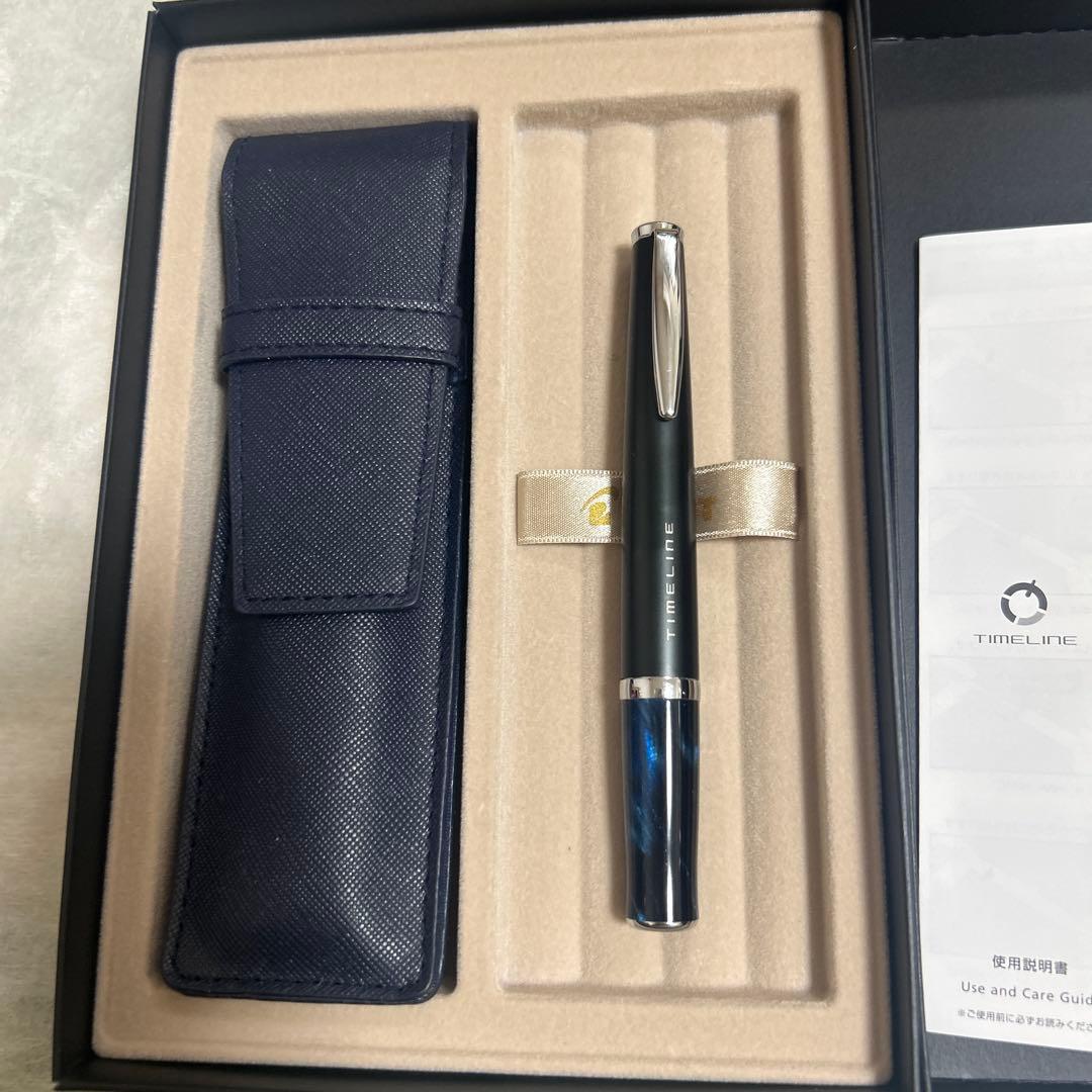 PILOT TIMELINE ballpoint pen with matte black body and blue marble grip alongside dedicated and pen cases