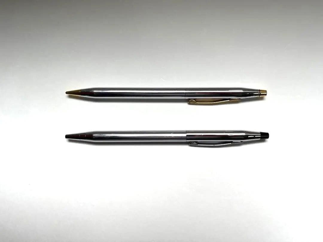 Cross ballpoint pen and mechanical pencil set shown without case, both in good condition with minor signs of use
