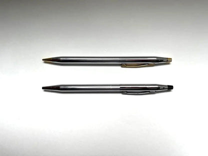 Cross ballpoint pen and mechanical pencil set shown without case, both in good condition with minor signs of use