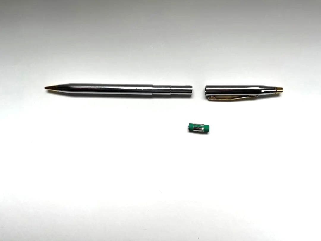 Cross ballpoint pen and mechanical pencil set shown without case, both in good condition with minor signs of use