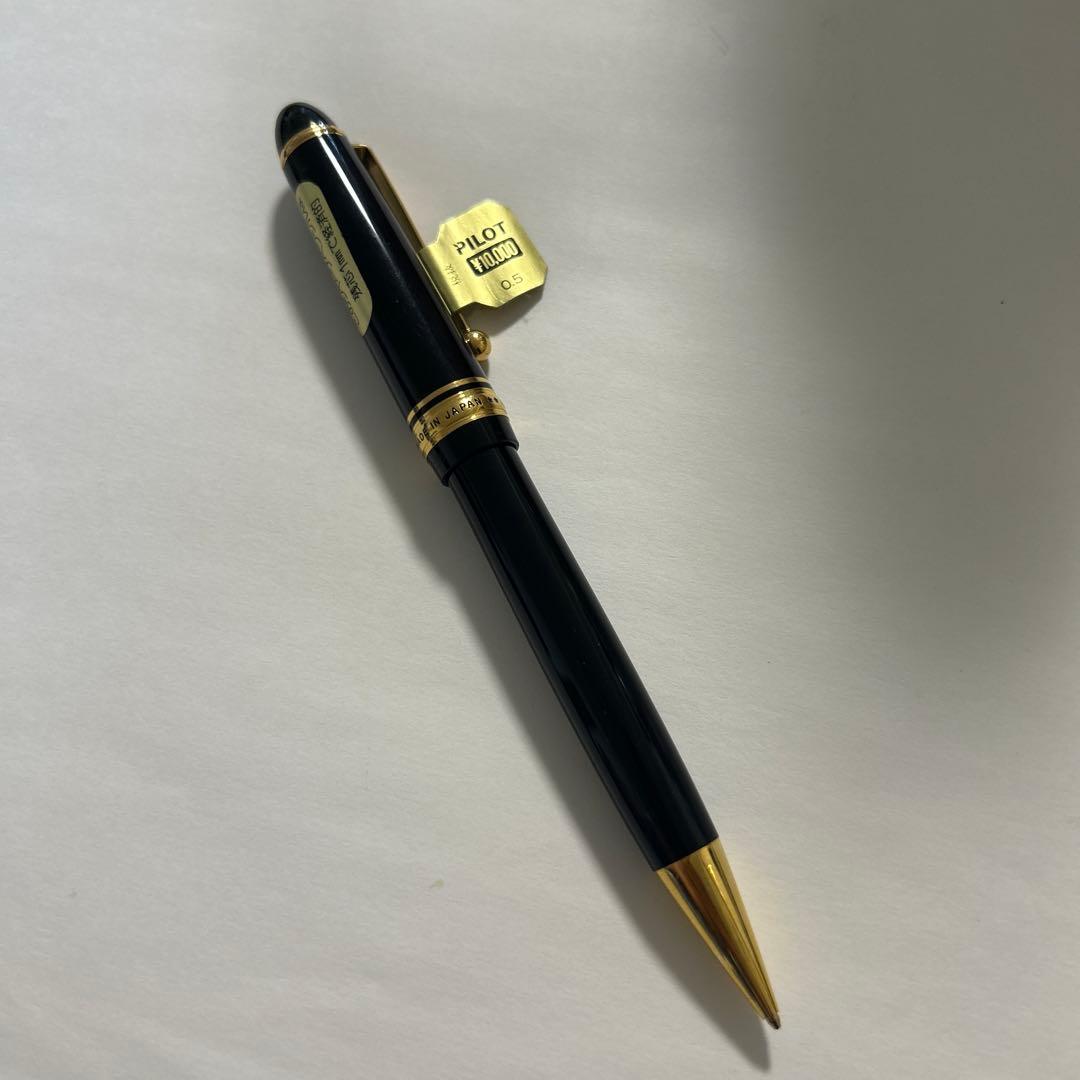 PILOT black ballpoint pen with gold accents and plastic body shown on white background
