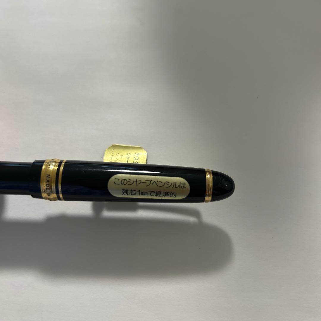 PILOT black ballpoint pen with gold accents and plastic body shown on white background