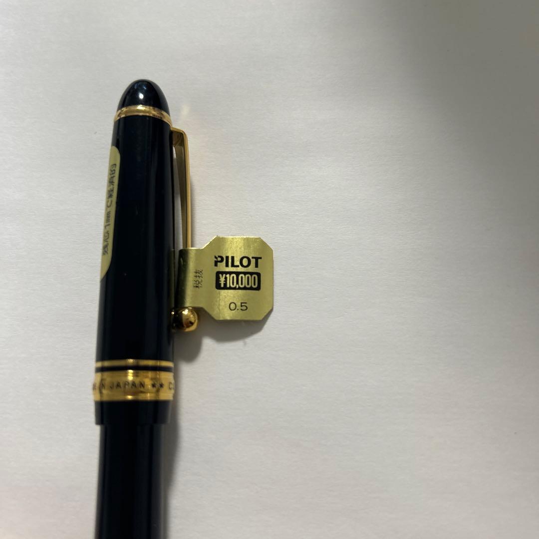 PILOT black ballpoint pen with gold accents and plastic body shown on white background