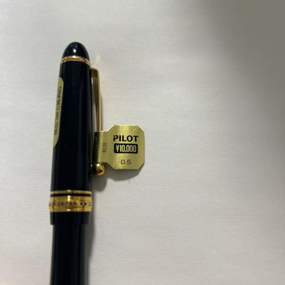 PILOT black ballpoint pen with gold accents and plastic body shown on white background