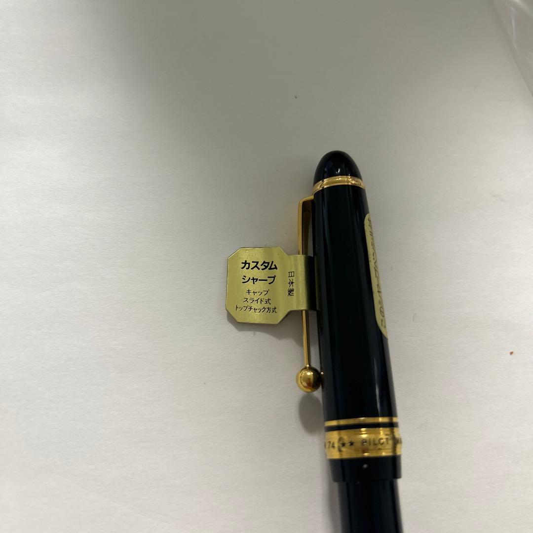 PILOT black ballpoint pen with gold accents and plastic body shown on white background