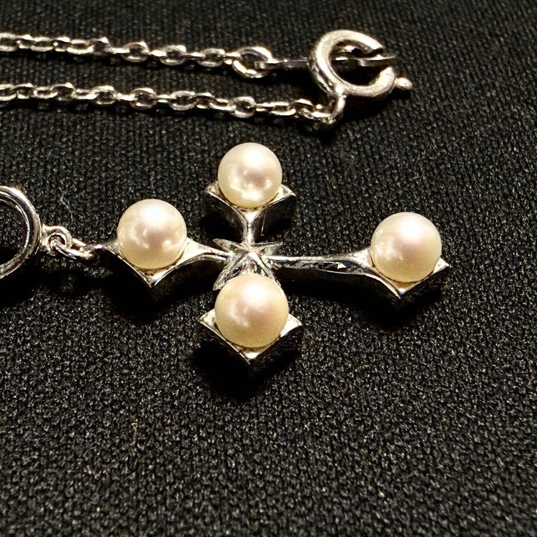 Mikimoto Akoya pearl cross necklace in silver with 19mm pearl and 42cm chain displayed on white background