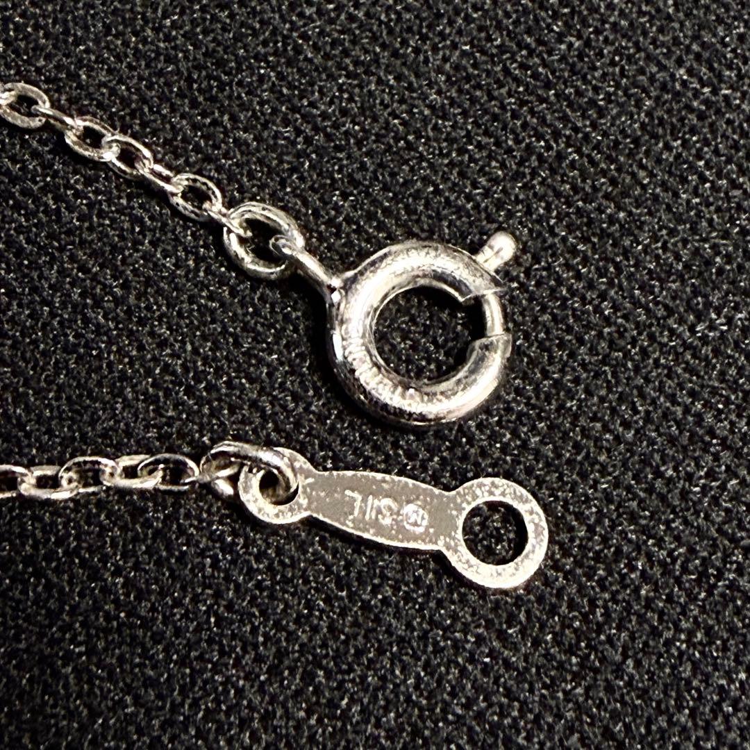 Mikimoto Akoya pearl cross necklace in silver with 19mm pearl and 42cm chain displayed on white background