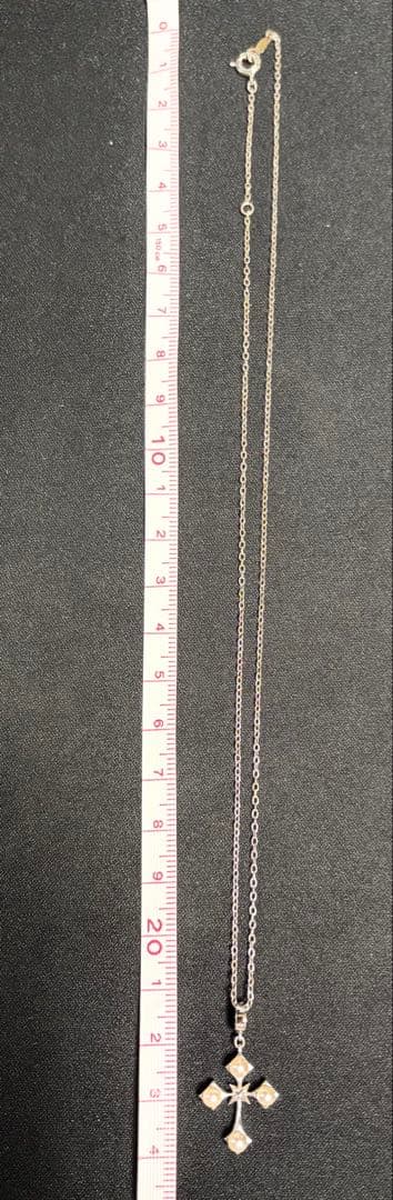 Mikimoto Akoya pearl cross necklace in silver with 19mm pearl and 42cm chain displayed on white background