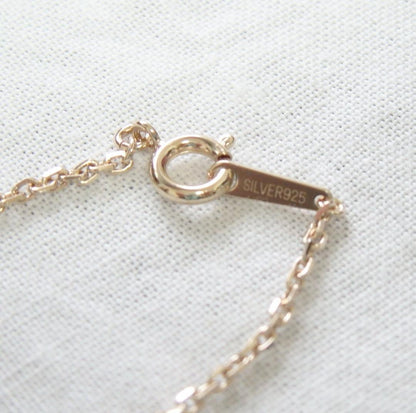 Chain Agete charm featuring topaz and diamond stones set in K10 gold with tourmaline, size 0.8 cm x 0.6 cm
